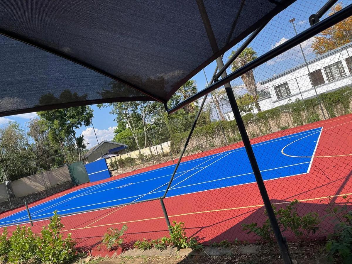 Blue and red multi-purpose court under shade netting